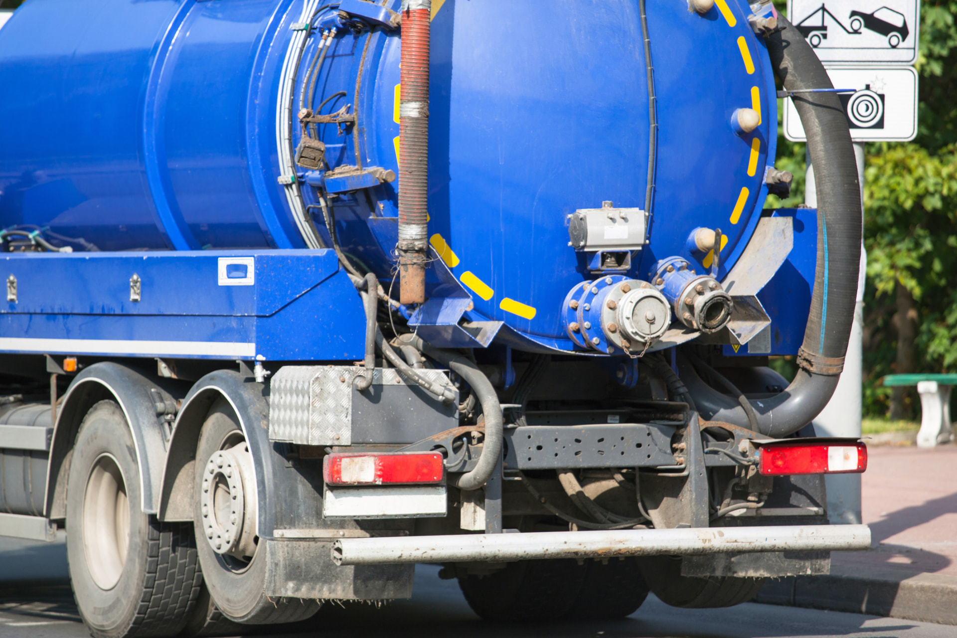 Blue tanker truck with pump and hose connections