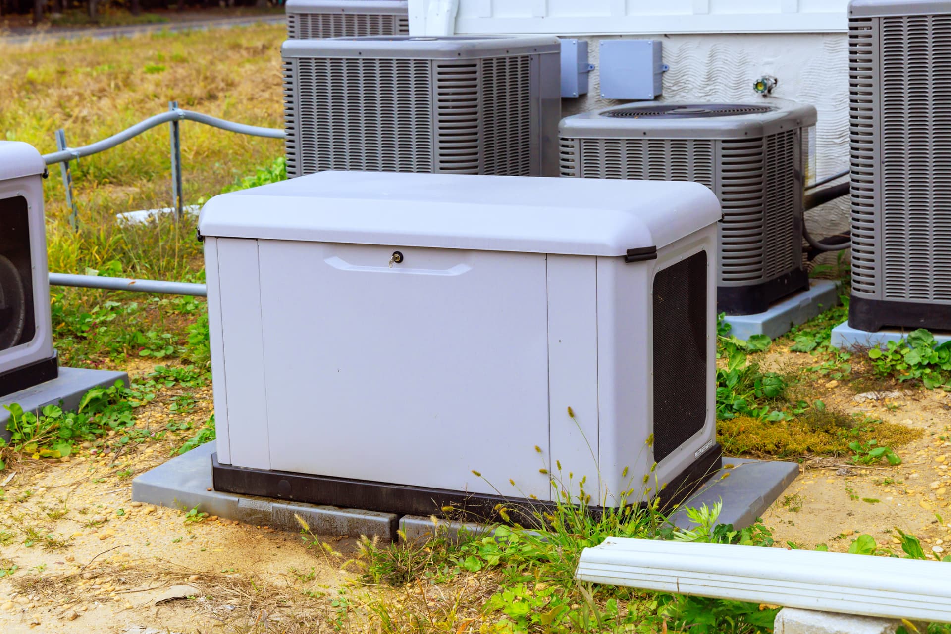 Standby generator beside HVAC condensers at a commercial property