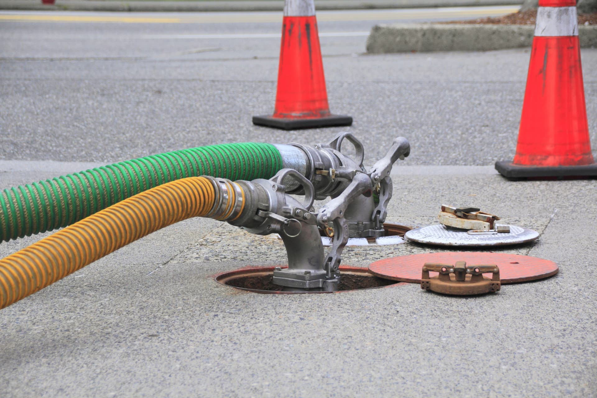 Hoses connected to an underground storage tank fill point