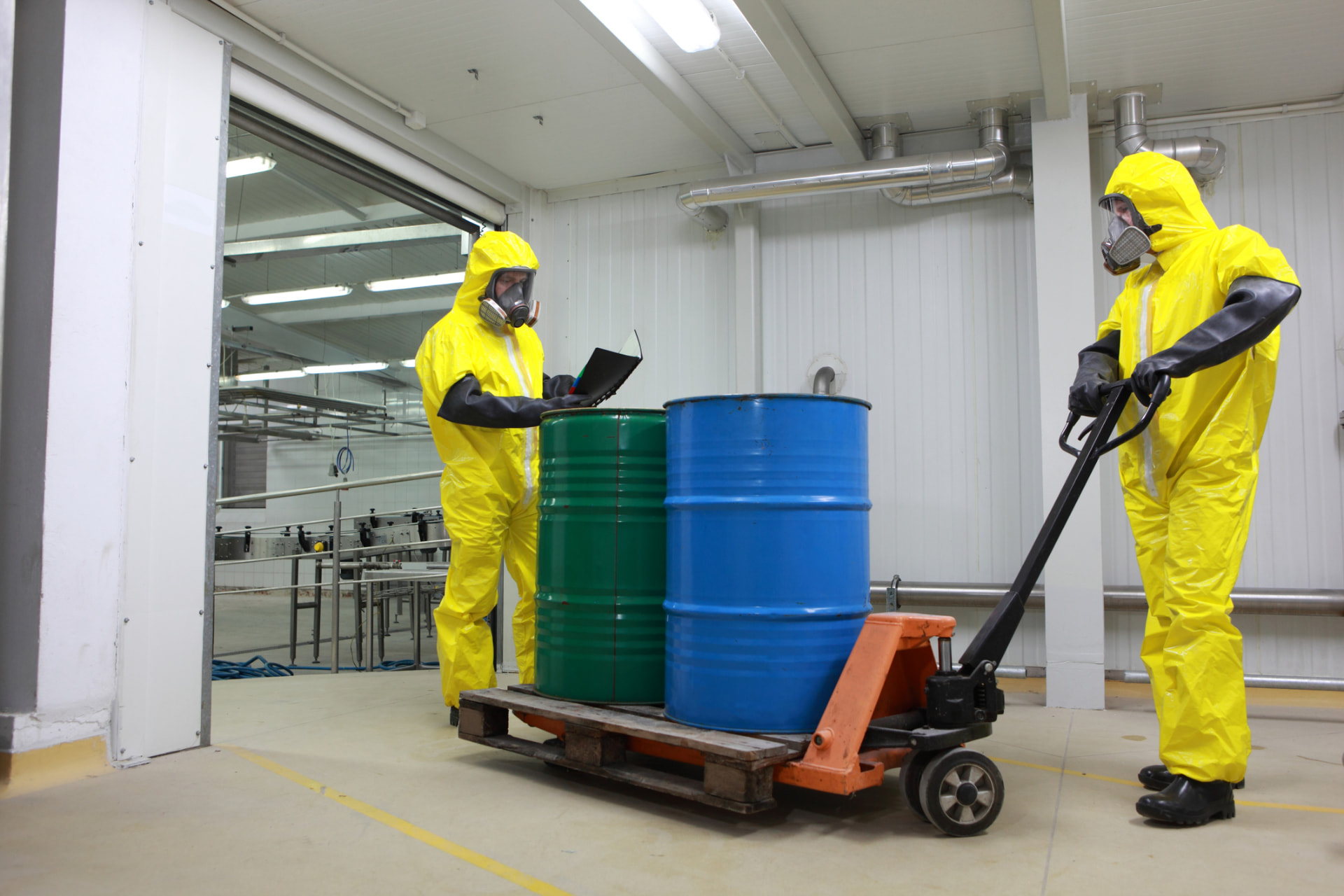 Crew logging and moving fuel drums on a pallet jack
